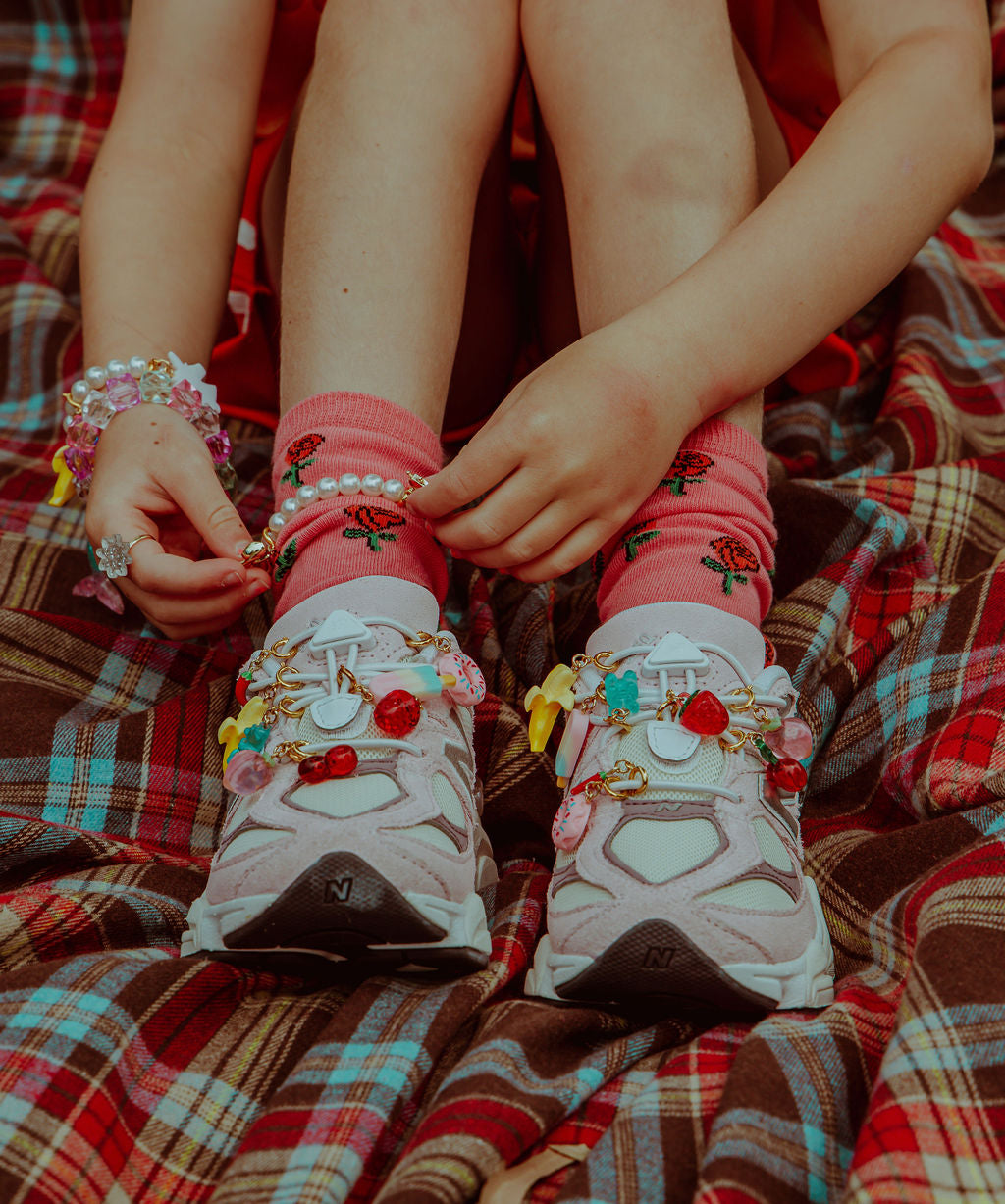 Charms and jibbitz for kids on New Balance 9060s. Colourful sneaker charms, jelly charms and glitter charms and accessories for kids. Shop Roger Accessories now.