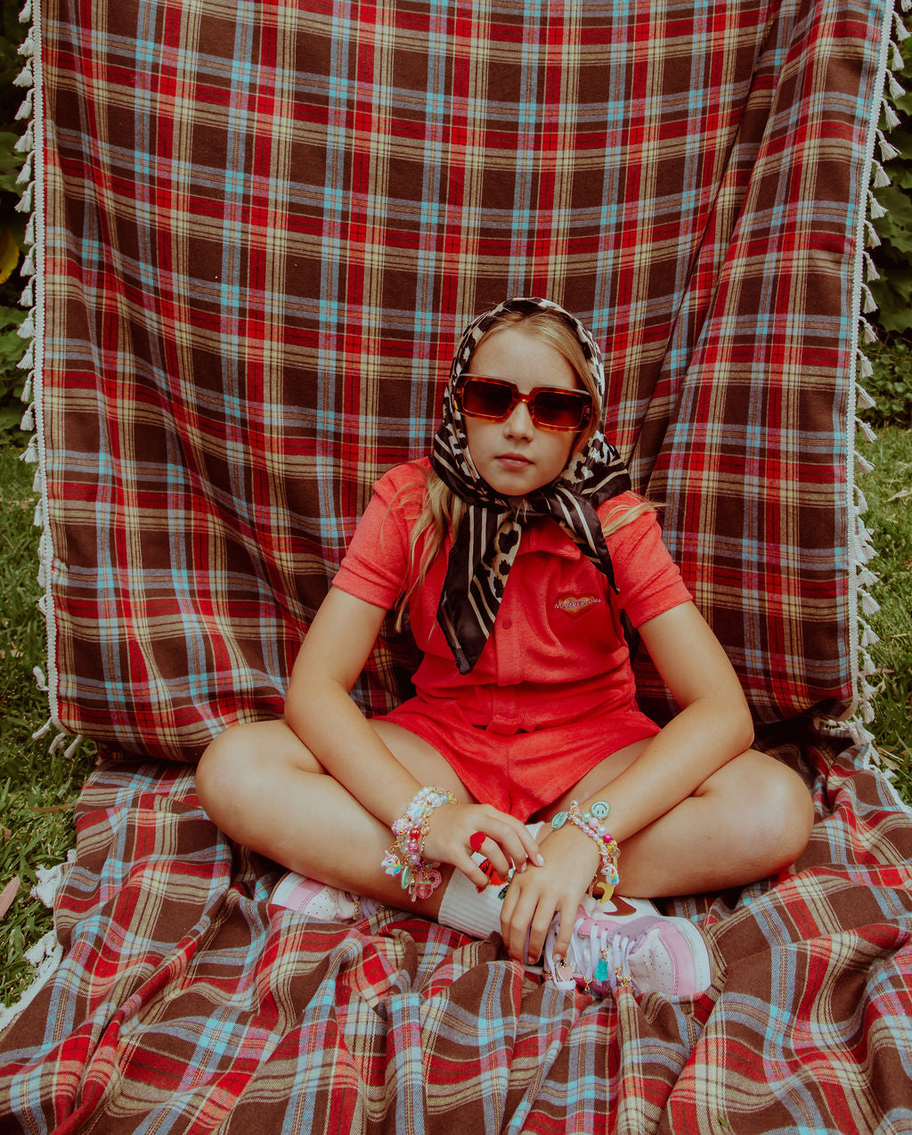 roger official charms mixed on shoes and jewellery. Girl sitting wearing charms and accessories by roger. Shop now