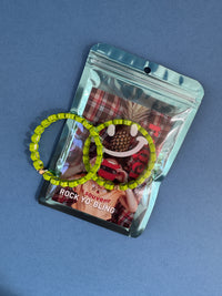 green heart bracelet in packaging