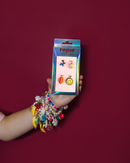 Hand holding a package of sneaker charms with a colorful background