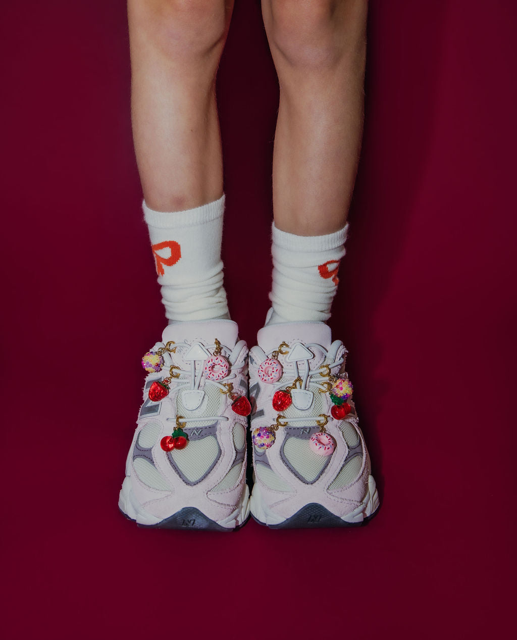 New Balance sneakers with shoe charms.