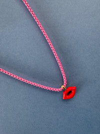 Pink chain with a red clasp on a gray background