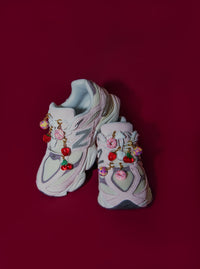 New Balance sneakers with Roger Shoe charms. Charms include; donut charm, cherry charm, strawberry charm and disco ball charm. 