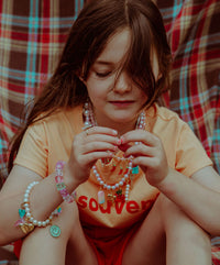 Girl wearing Roger Official charms on jewellery and shoes.