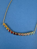 heart necklace with gold chain and rainbow gems