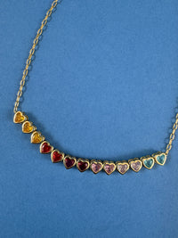 heart necklace with gold chain and rainbow gems