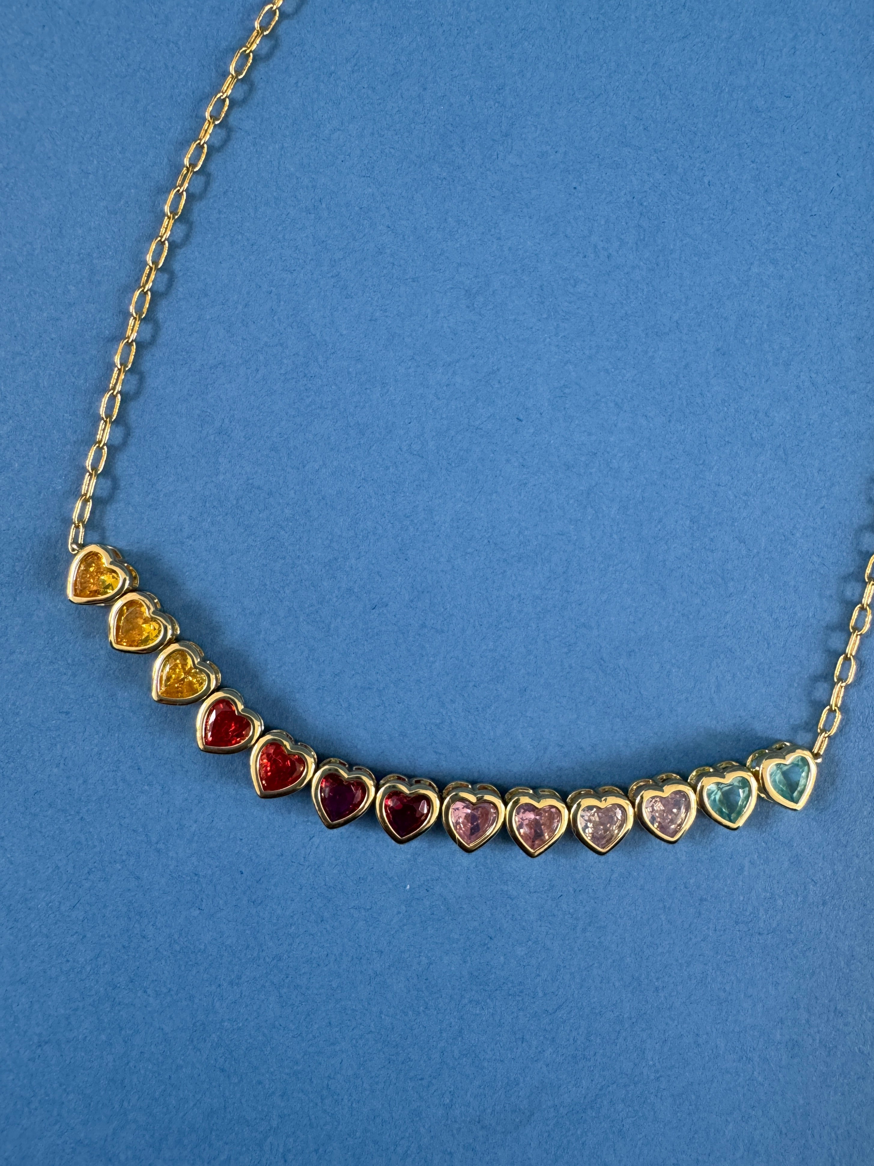heart necklace with gold chain and rainbow gems