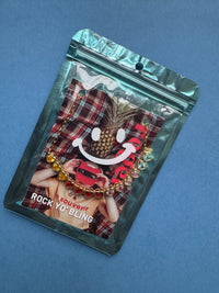 Packaged jewelry set with plaid pattern on a blue background